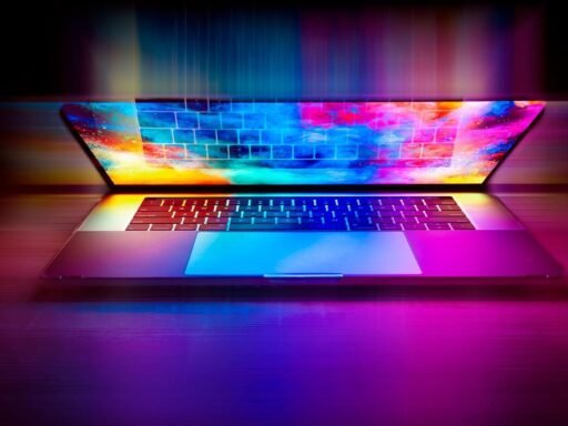 A half opened laptop with bright, multicolored light shining out of it.